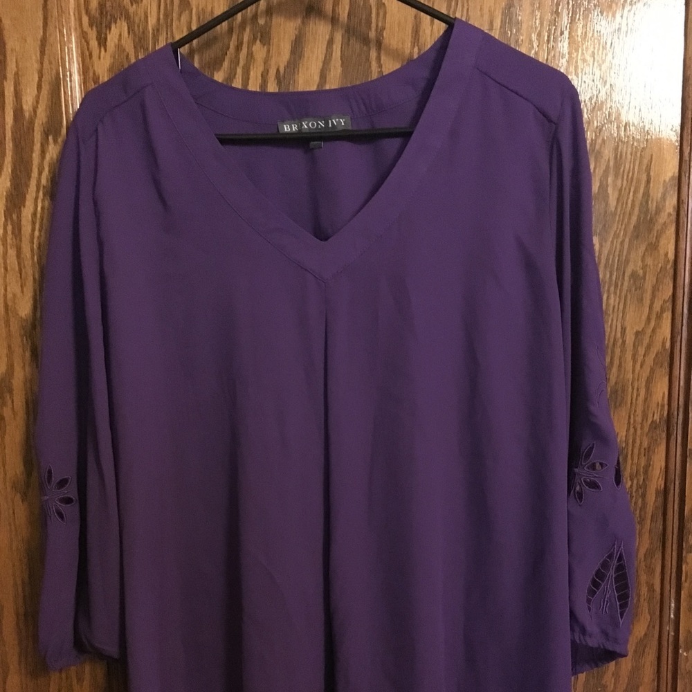 Purple blouse with cut-out sleeves.